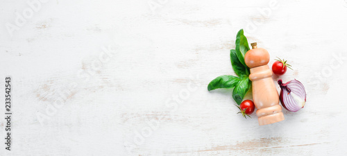 Fresh basil and spices. On a white wooden background. Top view. Free copy space.