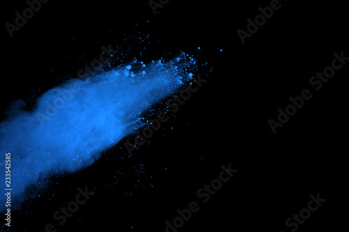 Freeze motion of blue powder explosions isolated on black background.
