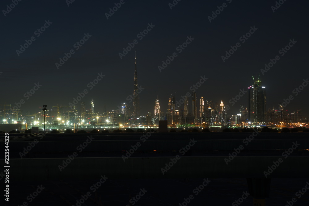 Dubai skyline at night from Al Meydan Hotel and district, Dubai downtown and Business Bay area