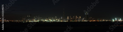 Dubai skyline at night from Al Meydan Hotel and district, Dubai downtown and Business Bay area