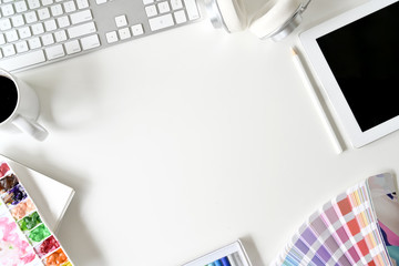 Artist designer white desk workspace with colour and supplies
