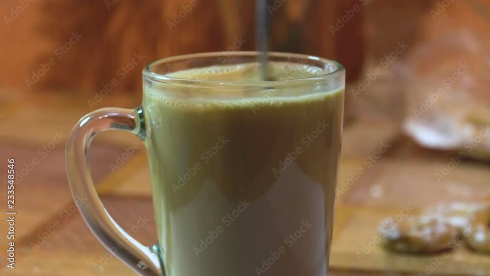 Preparation of coffee. The addition of milk. Transparent glass mug. The mixture of ingredients. Fragrant smell. Home interior. Unique taste. Without man. 4K video Preparation of coffee. The addition of milk. Transparent glass mug. The mixture of ingredients. Fragrant smell. Home interior. Unique taste. Without man. 4K video