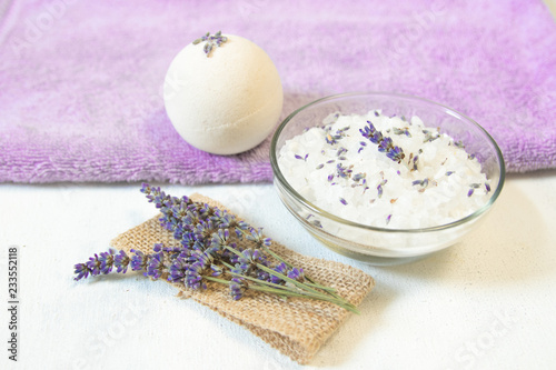 Natural herbal sea salt with aromatic lavender - perfect for relaxation. Cosmetic jars and bottles with salt, lavender flowers, bath bomb