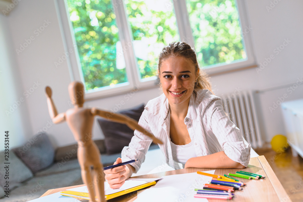 Woman learning to draw in her apartment Woman learning to draw in her apartment