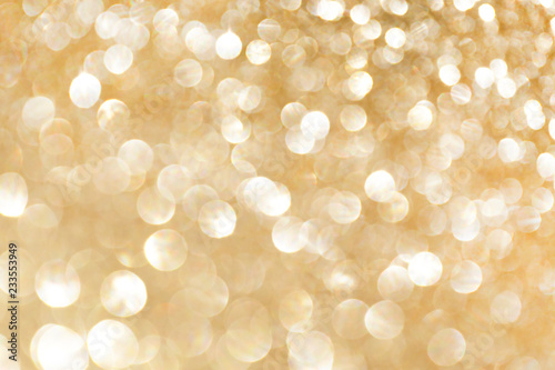 Golden sparkle glitters with bokeh effect and selectieve focus. Festive background with bright gold lights, champagne bubble. Christmas mood concept. Copy space, close up, texture, top view. photo