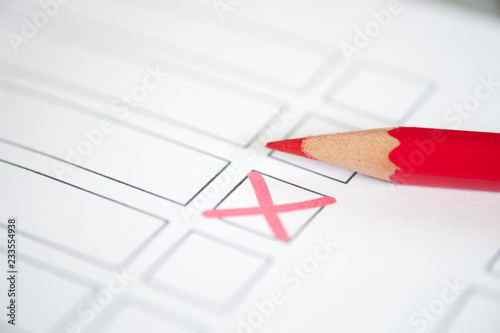 Close up voting bulletin with red pencil. Concept of election.