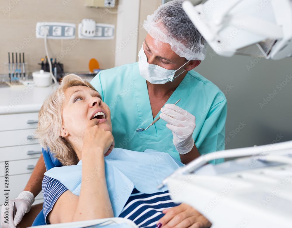 © JackF - Dentist performing treatment to woman