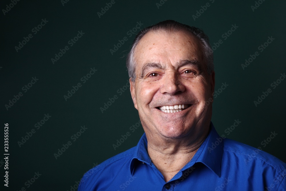 Beautiful older man in front of a colored background Beautiful older man in front of a colored background