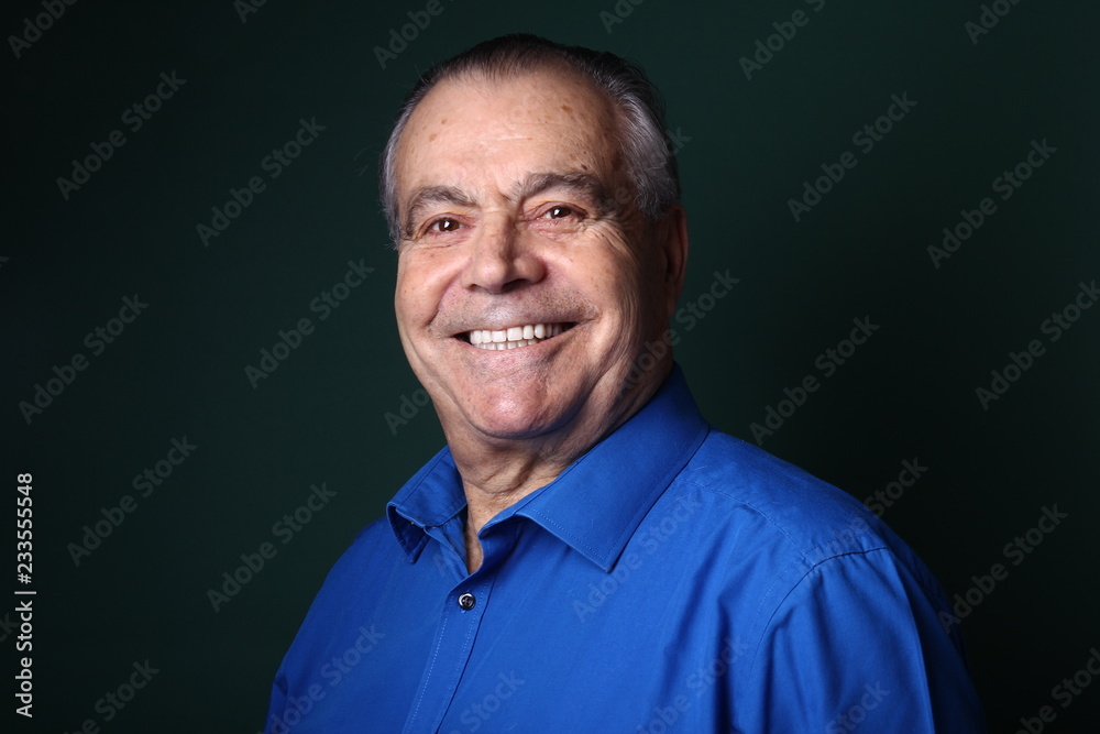 Beautiful older man in front of a colored background Beautiful older man in front of a colored background