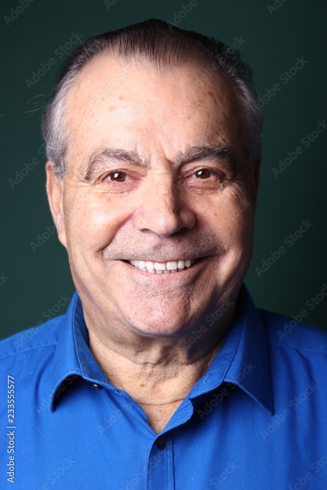 Beautiful older man in front of a colored background Beautiful older man in front of a colored background