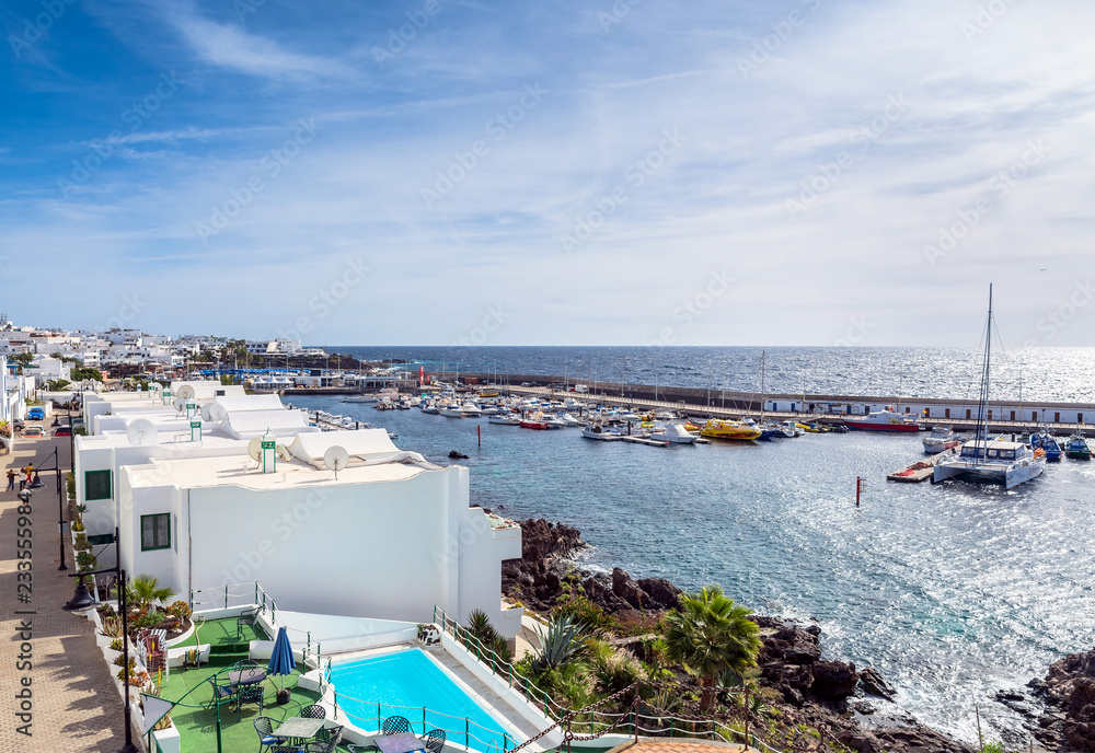 old town and port boardwalk with tourists in Puerto del Carmen, Stock
