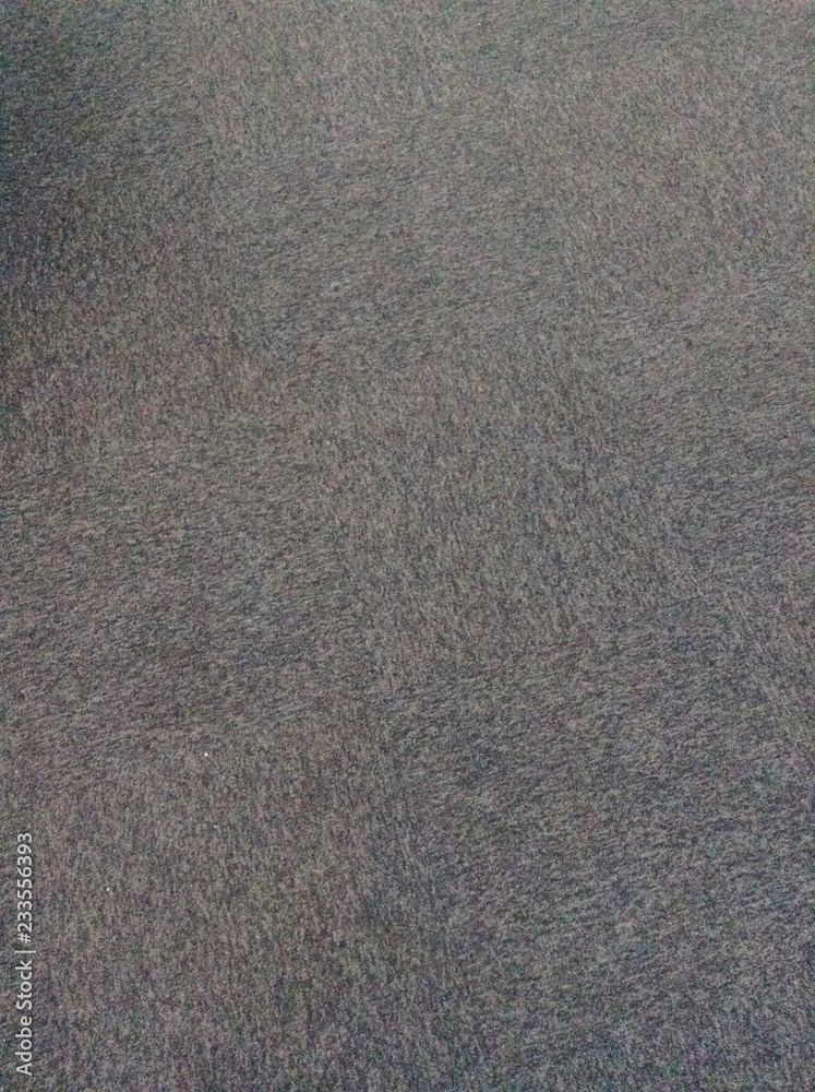 Dark gray background or texture of digital noise or grain of asphalt, graphite.