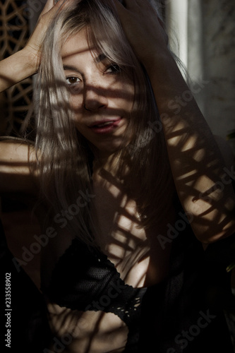 Young sexy woman with shadow pattern on body and face © Iryna