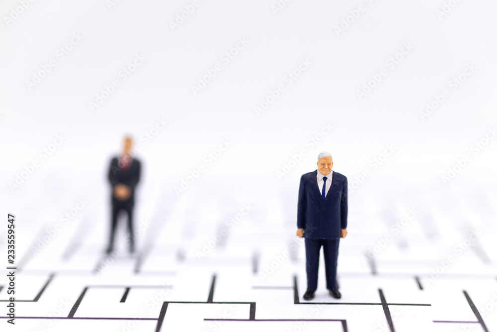 Miniature people: Businessman standing with a maze to background. Image use for find solution, business concept.