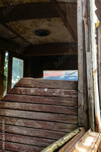 Wooden chair in old rusty destroyed tram. © angor75