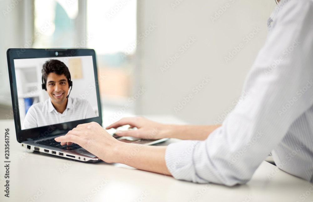 business, technology and communication concept - close up of businesswoman with laptop computer having video call with partner or customer service operator at office business, technology and communication concept - close up of businesswoman with laptop computer having video call with partner or customer service operator at office