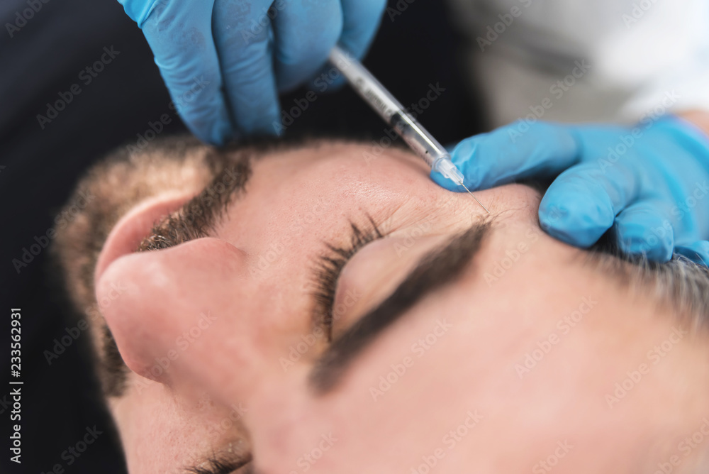 Man having fillers injectioning Man having fillers injectioning