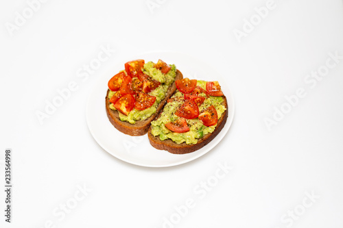 Avocado toast. Healthy toast with avocado mash and cherry tomatoes on a plate.