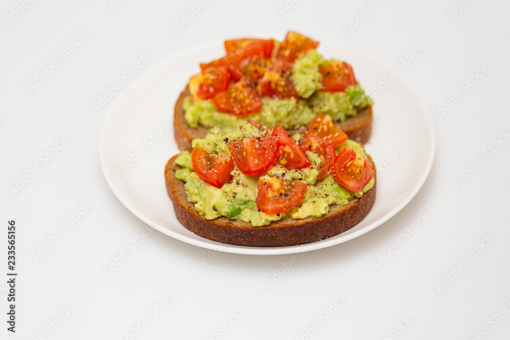 Avocado toast. Healthy toast with avocado mash and cherry tomatoes on a plate. Avocado toast. Healthy toast with avocado mash and cherry tomatoes on a plate.