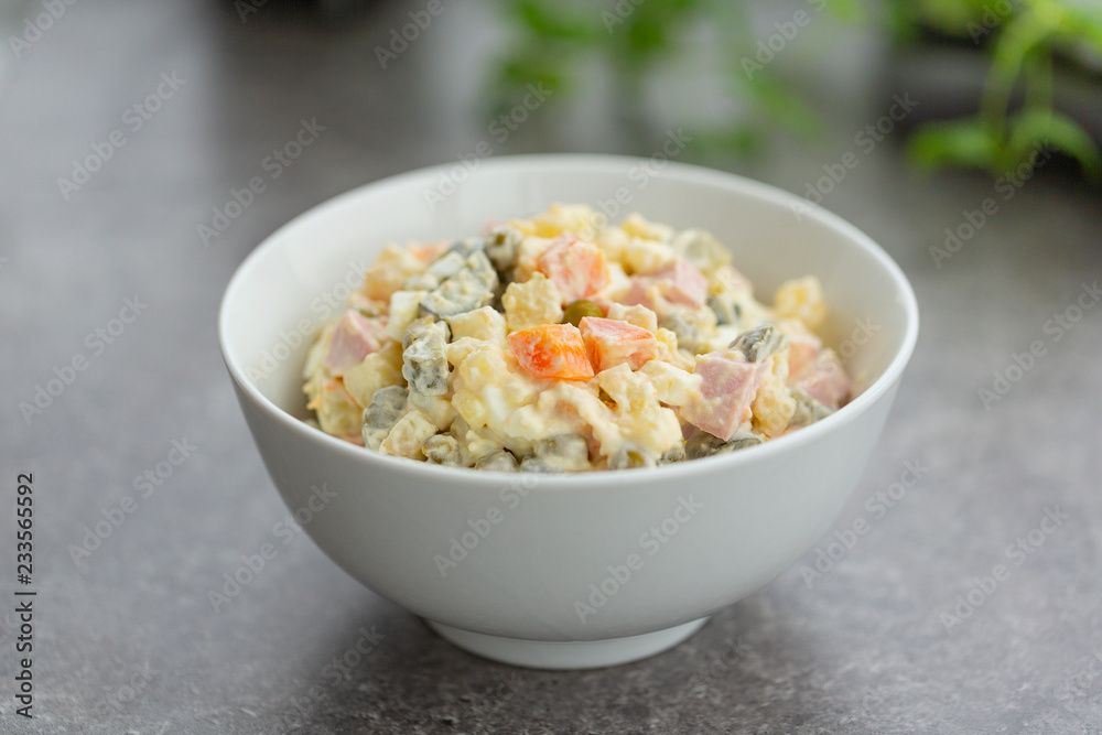 Russian salad in white bowl. National cuisine. Russian traditional salad Olivier for New Year party. Russian salad in white bowl. National cuisine. Russian traditional salad Olivier for New Year party.