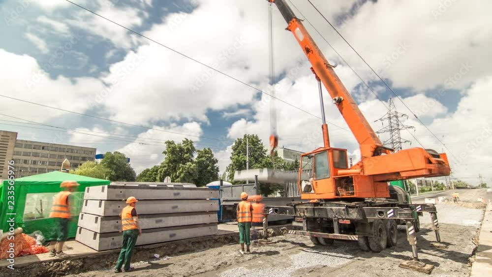 Unloading concrete plates from truck by crane at road construction site timelapse. Unloading concrete plates from truck by crane at road construction site timelapse.