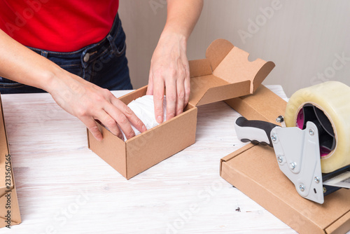 Canvas Print Woman packing cardboard boxes , picking and puttind products