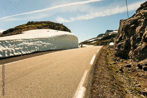 Tourist taking photo from high snow wall at road, Norway photo