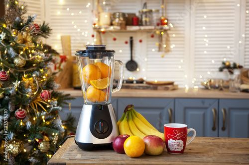Christmas in the kitchen.Blender with fruit on the table