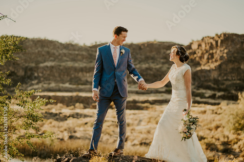 Beautiful Couple on their Wedding day in front of landscape © MeganBetteridge