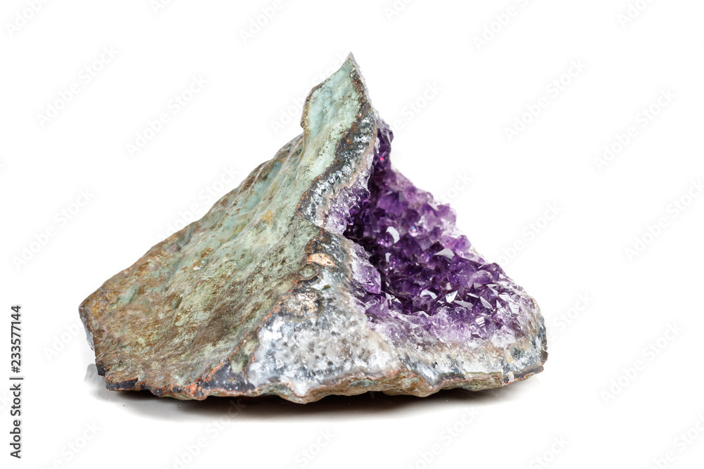 Macro Mineral Stone Amethysts in the rock on a white background