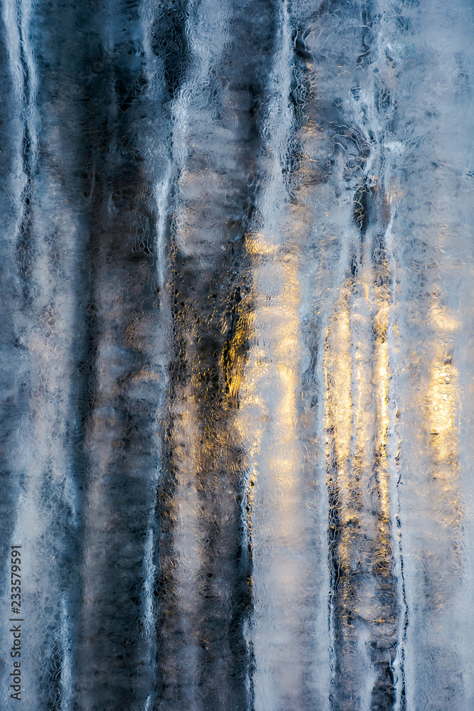 Fototapeta premium beautiful ice texture lit from behind. ice and sun, cold and warm, winter and spring resistance concept