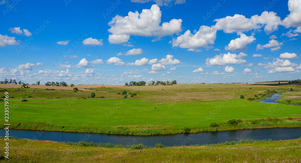 Sunny summer landscape with fields,bending river and beautiful woods.