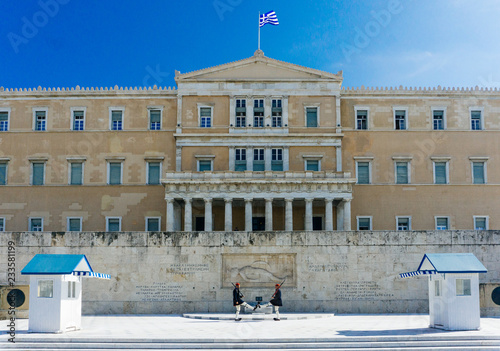 Athens, Greece — November 11, 2018: Evzones or Evzonoi guarding the Tomb of the Unknown Soldier at the Hellenic Parliament building (the Old Royal Palace) on Syntagma Square in Athens, Greece. photo