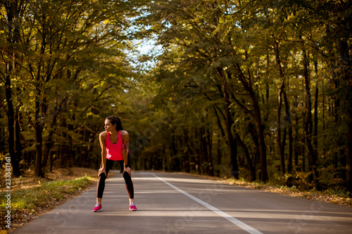 Wallpaper Mural Young woman have a break during training in the autumn forest Torontodigital.ca