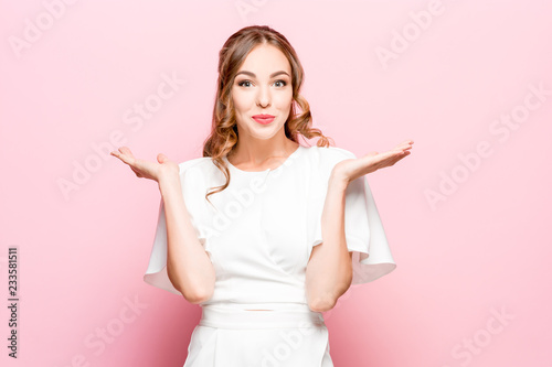 Delight. Beautiful female half-length front portrait isolated on pink studio backgroud. Young, emotional, smiling, surprised woman standing. Human emotions, facial expression concept. Trendy colors