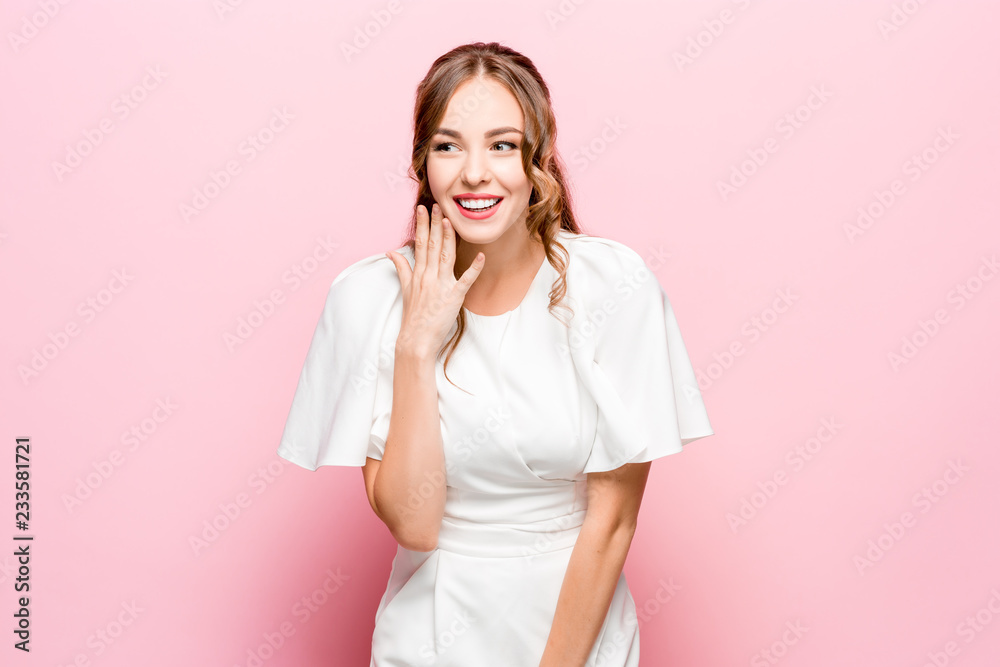 Happy business woman standing and smiling isolated on pink studio background. Beautiful female half-length portrait. Young emotional woman. The human emotions, facial expression concept Happy business woman standing and smiling isolated on pink studio background. Beautiful female half-length portrait. Young emotional woman. The human emotions, facial expression concept
