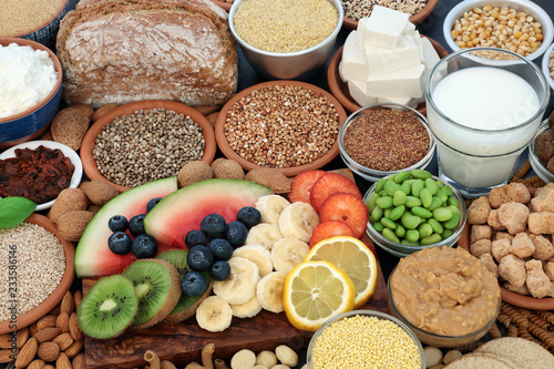 Health food for vegans with almond butter, yoghurt & milk, tofu bean curd, grains, seeds, nuts, fruit, vegetables, cereals, soy bean mix, pasta & bread. High in antioxidants, dietary fibre & omega 3.