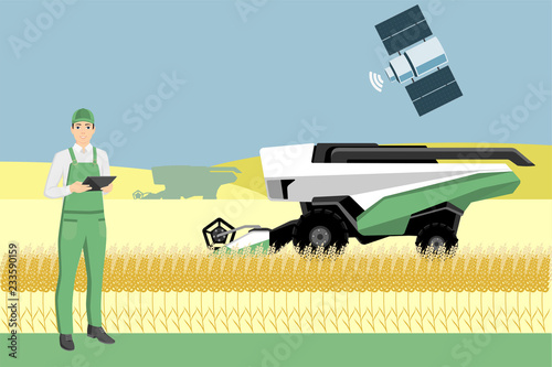 Farmer controls an autonomous combine harvester via satellite. Internet of things in agriculture