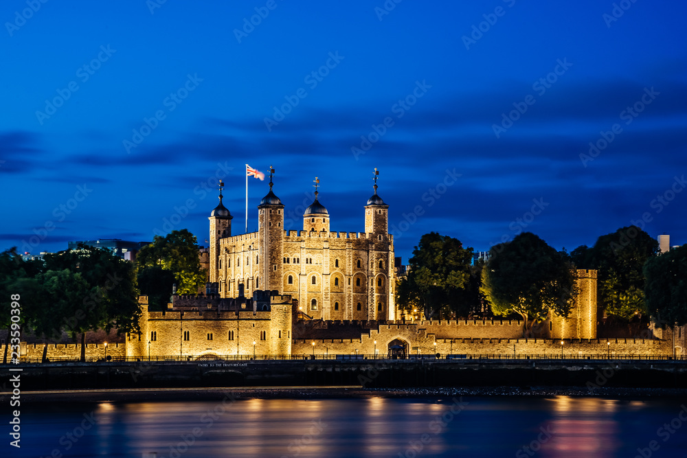 Night view of the Tower of London, England across Thames River