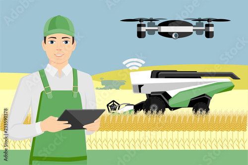 Farmer controls an autonomous combine harvester and drone. Internet of things in agriculture
