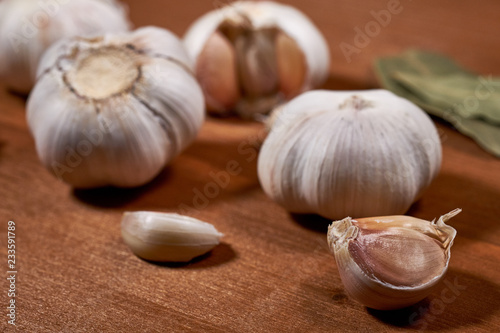 Garlic and garlic cloves on wooden background. Selective focus