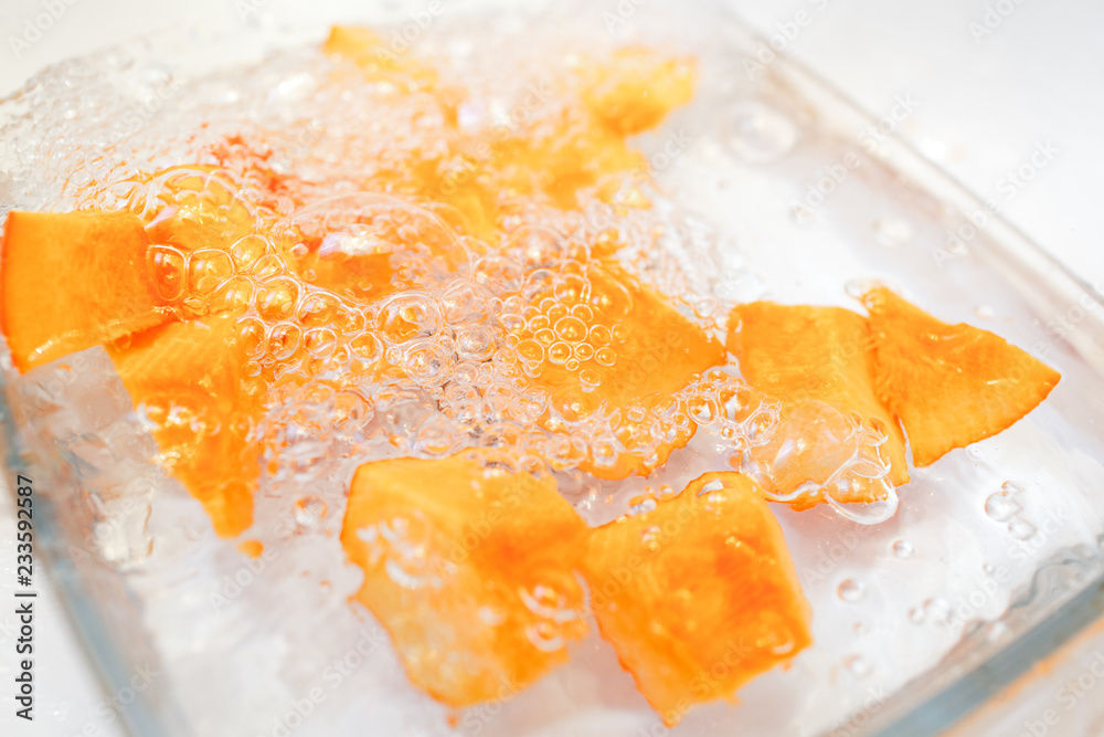 Sliced pumpkin on a plate in a water Sliced pumpkin on a plate in a water