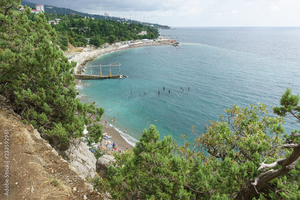 view from the mountain to a small beach near the rock Diva in the resort black sea village Simeiz