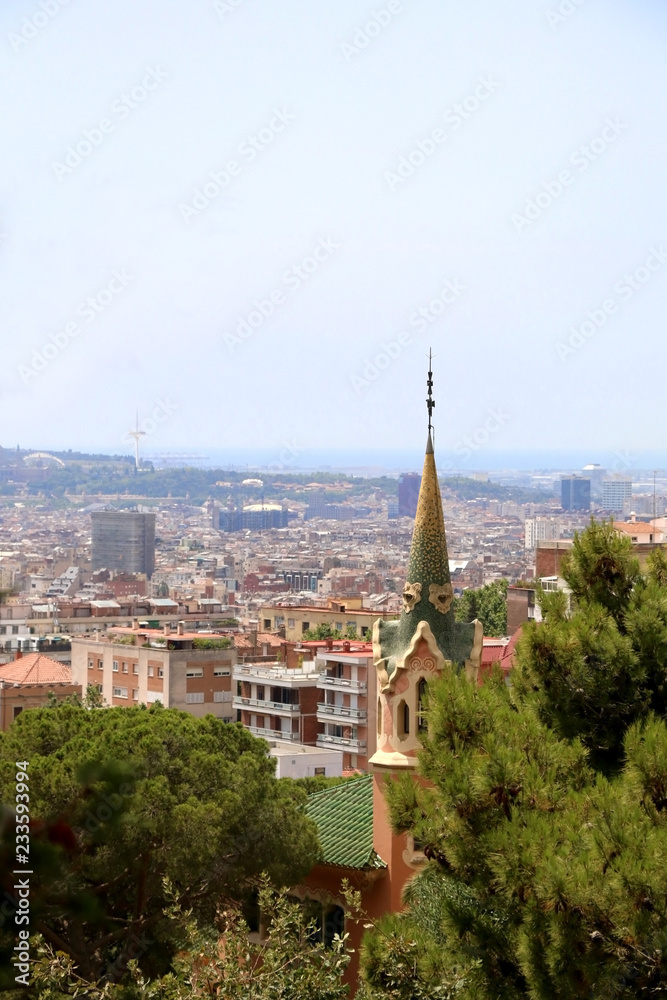View of Barcelona from Park Güell with The Gaudi House Museum in the foreground.