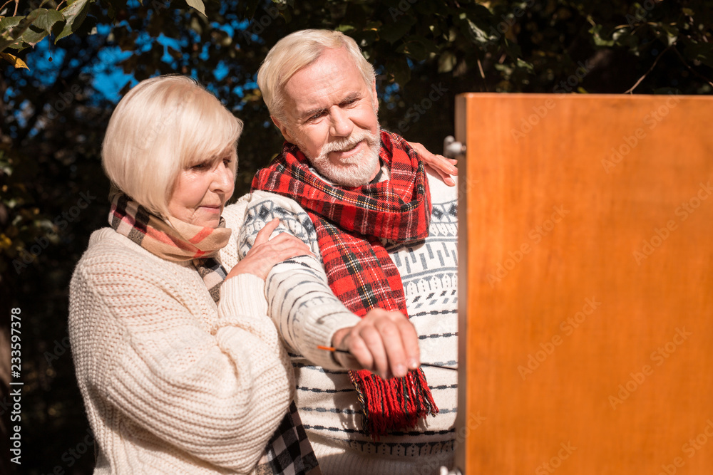 Joyful nice aged couple enjoying modern art Joyful nice aged couple enjoying modern art