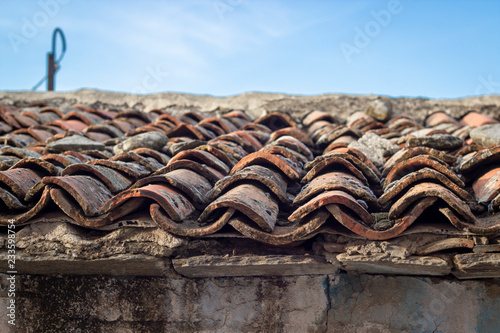 Close-up shoot of corner of masonry roof structure tiles at old ruined building