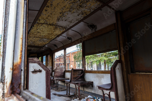 Old rusty wagon of destroyed tram outdoors.