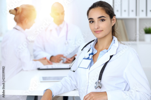 Portrait of young doctor woman in hospital. Hispanic or latin american staff in medicine