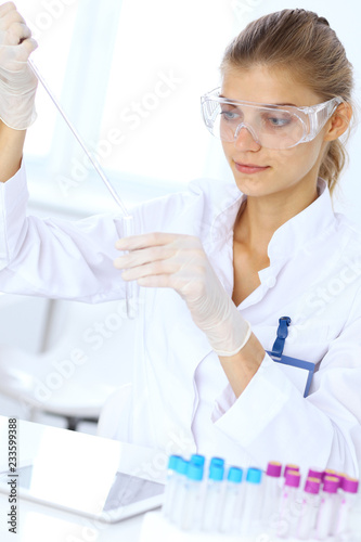Female scientific researcher or blood test assistant at work in laboratory. Science  medicine and pharmacy concept
