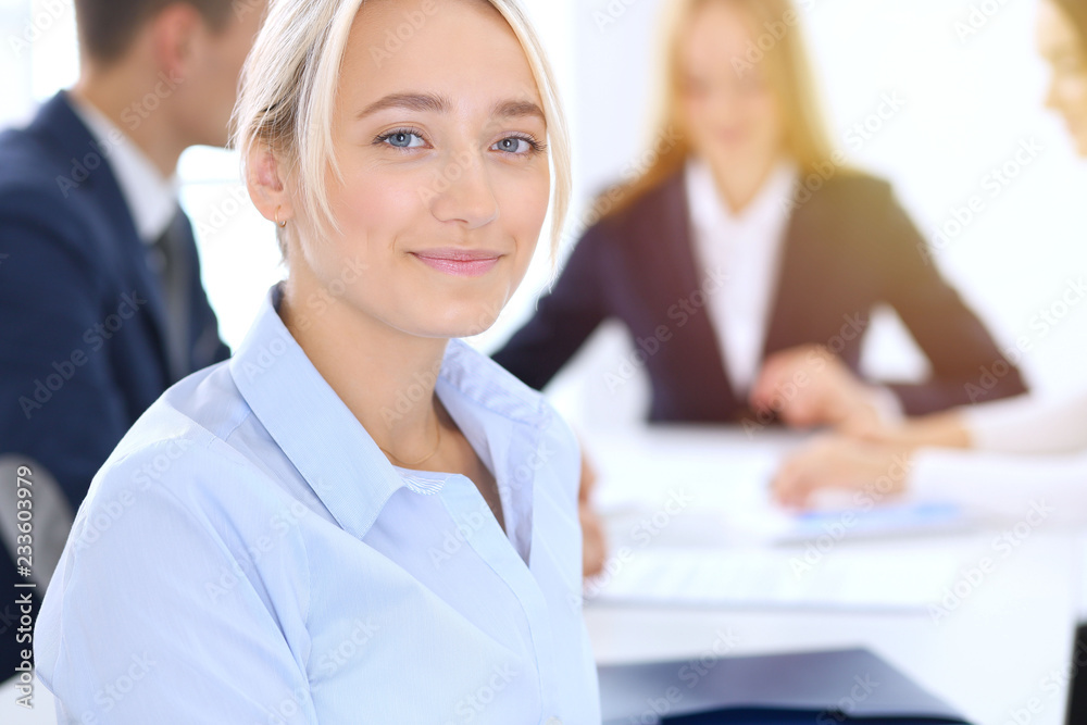 Group of business people or lawyers discussing terms of transaction in office. Focus at young business woman. Meeting and teamwork concept Group of business people or lawyers discussing terms of transaction in office. Focus at young business woman. Meeting and teamwork concept